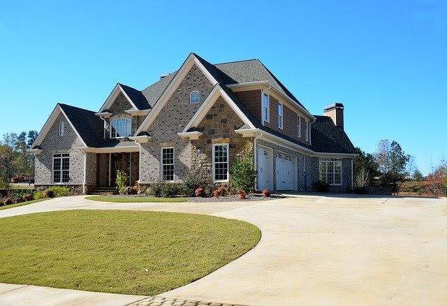 Residential home with stone exterior and large driveway