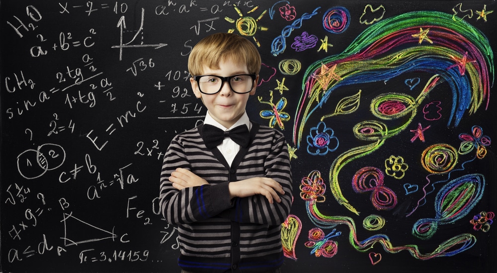 Little boy behind blackboard
