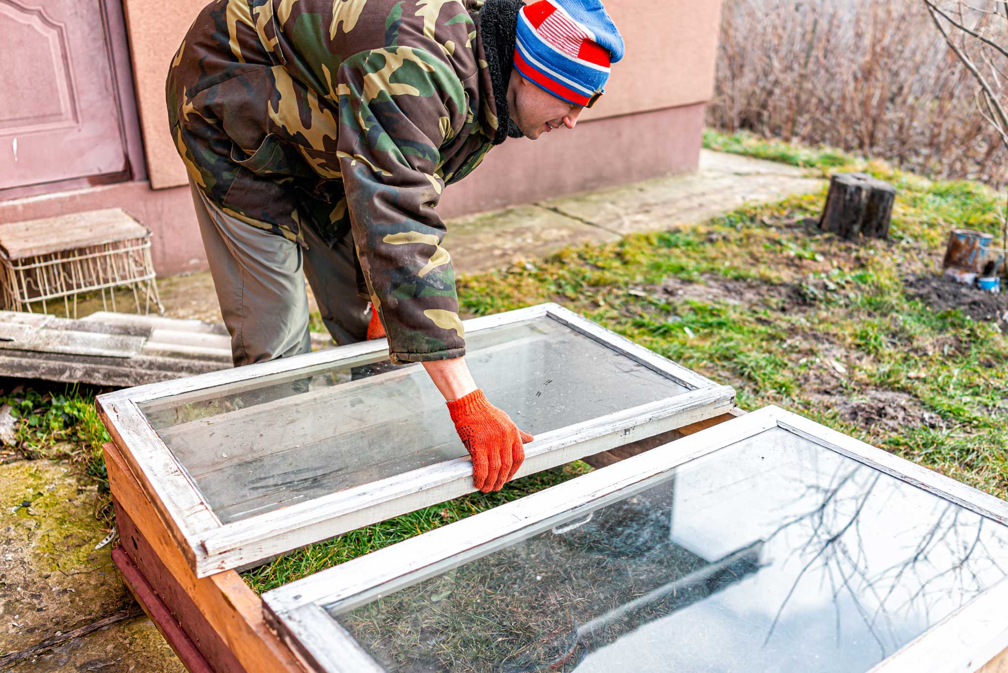 A man making a DIY rustic table from old windows