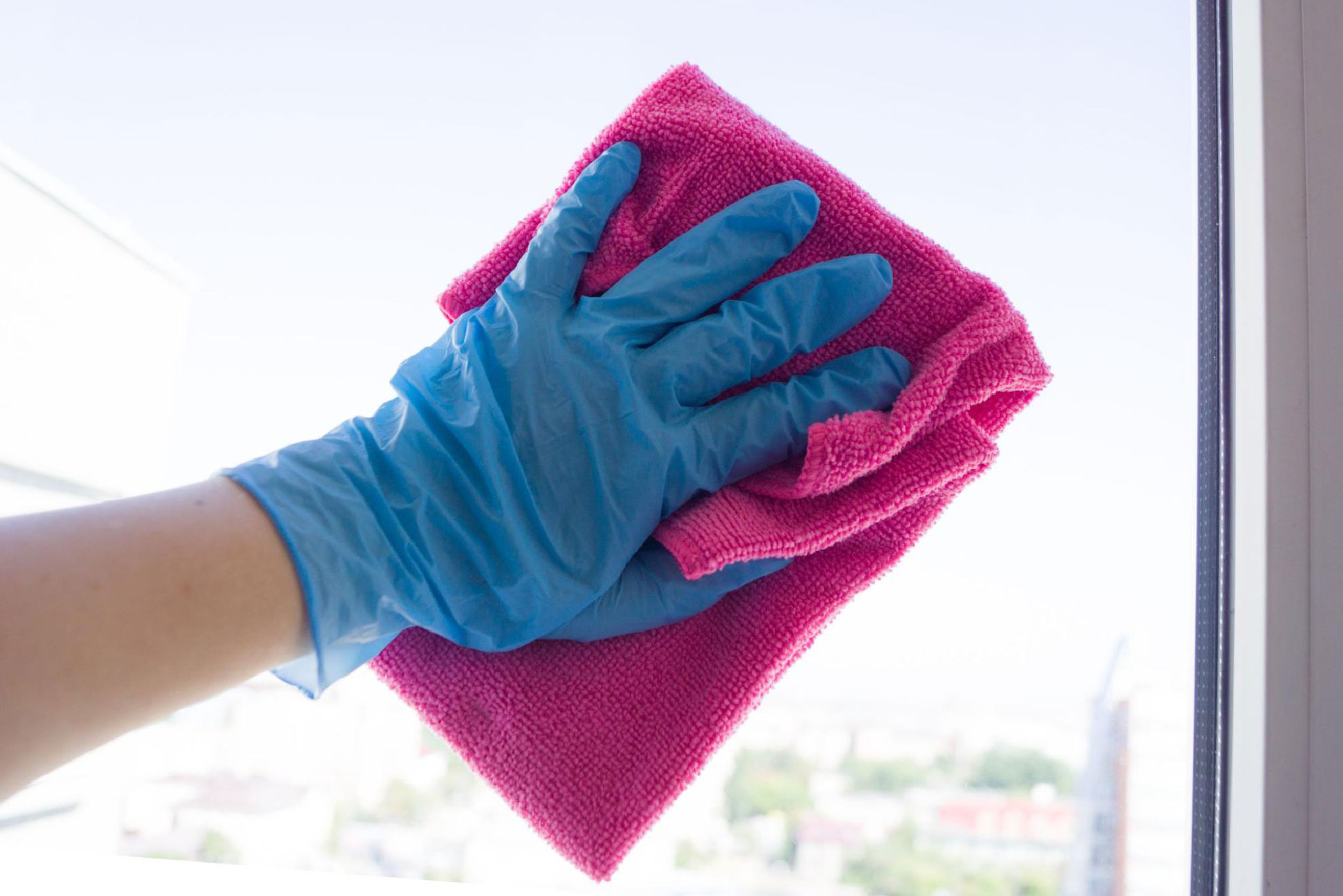 Close-up of a hand cleaning vinyl windows