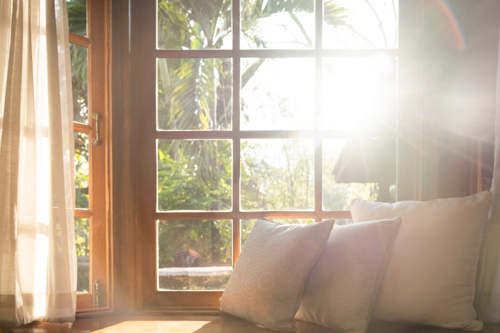 a bay window reading nook shining in lots of natural light