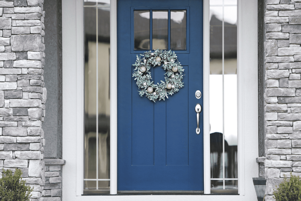 A blue custom exterior door with sidelights.