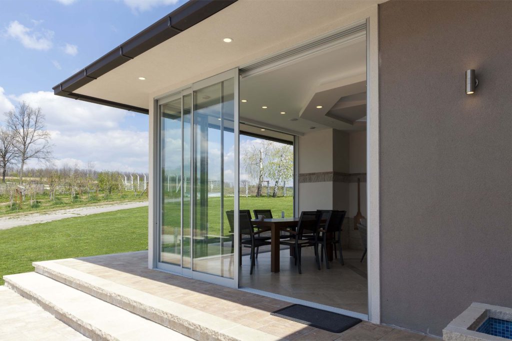 A sliding patio door leading to an open yard