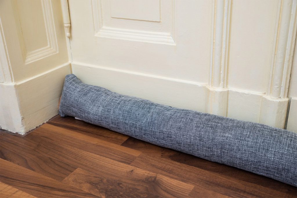 A draught excluder blocking cold air from entering a home