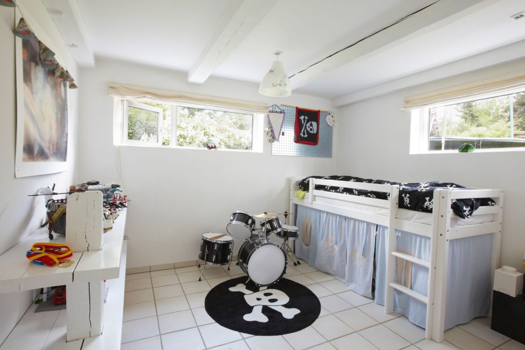 A below-ground-level room with mixed casement and picture windows
