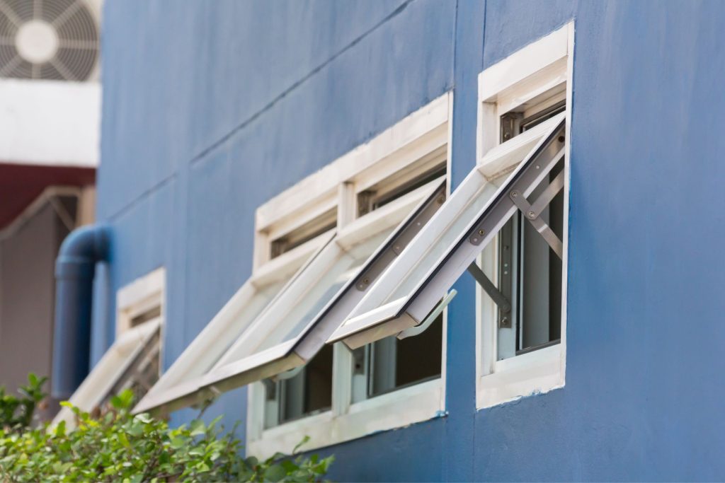  A row of opened white awning windows