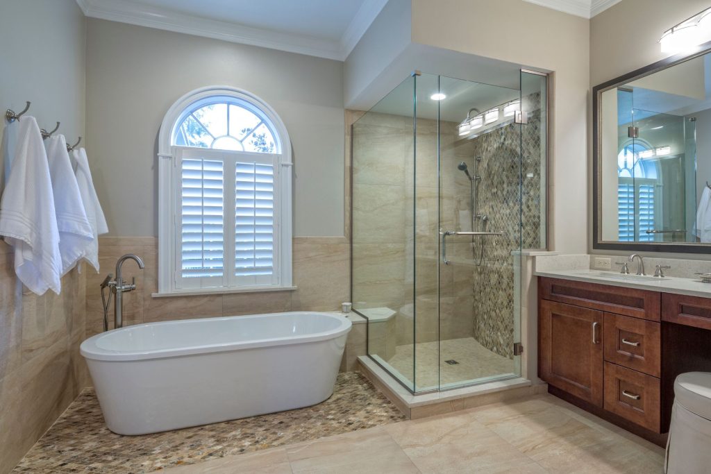 A modern-style bathroom with a casement window with wooden blinds