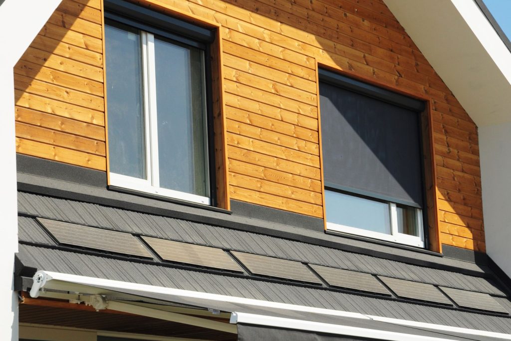 Motorized solar shades installed outside sliding windows