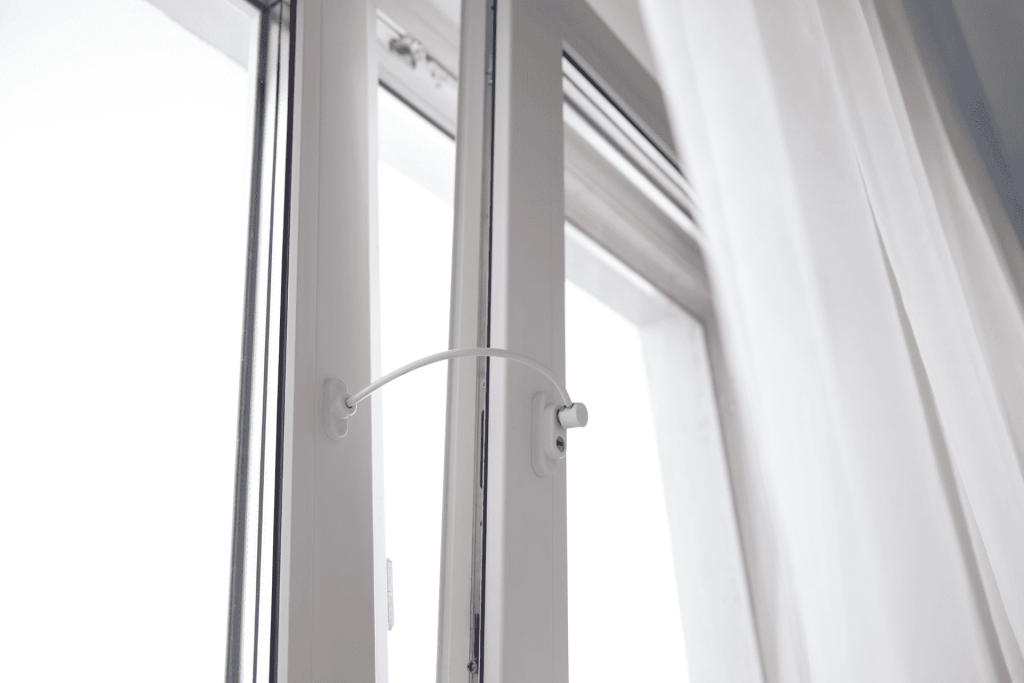White casement window with child safety window lock