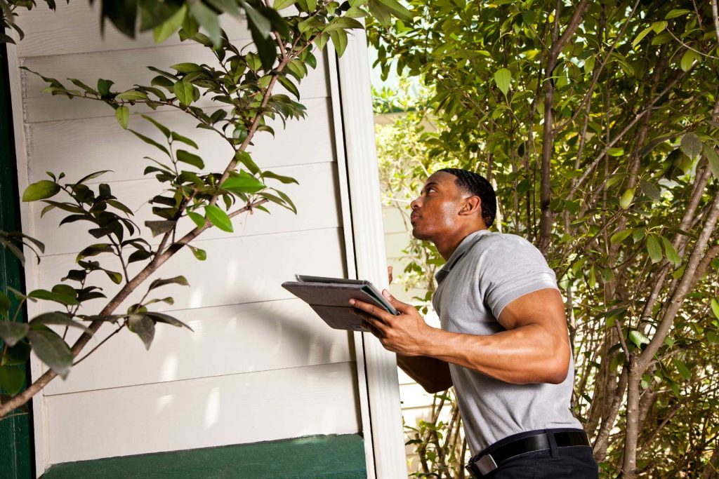 Industry professional inspecting windows on an Ontario home for drafty windows