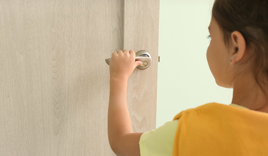A child opens a door