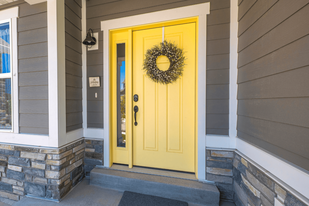 Yellow front door with sidelight